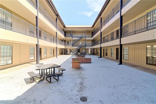 a view of a patio with table and chairs and potted plants