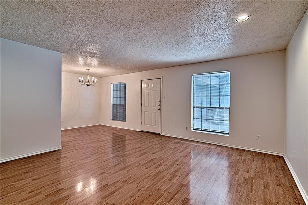 2401 Leon Street, Unit 104 Austin, TX 78705 - Photo 3 of 21 a view of an empty room with wooden floor and a window