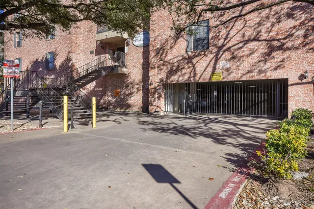 a front view of a house with a tree
