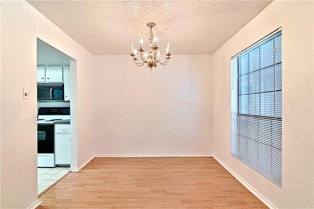 2401 Leon Street, Unit 104 Austin, TX 78705 - Photo 4 of 21 wooden floor in an empty room with a window