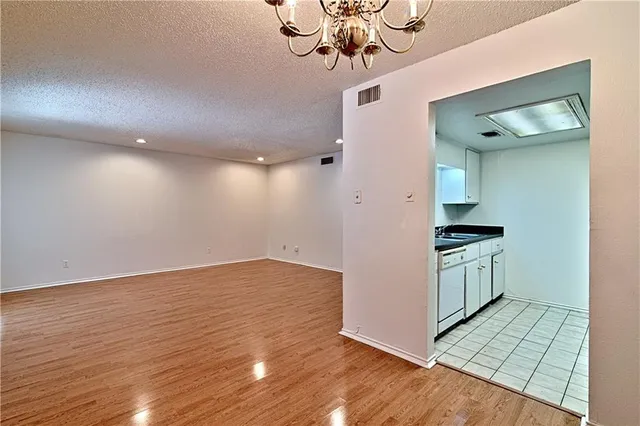 a kitchen with a sink cabinets and wooden floor