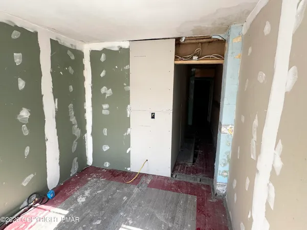 a view of a hallway with entryway and front door