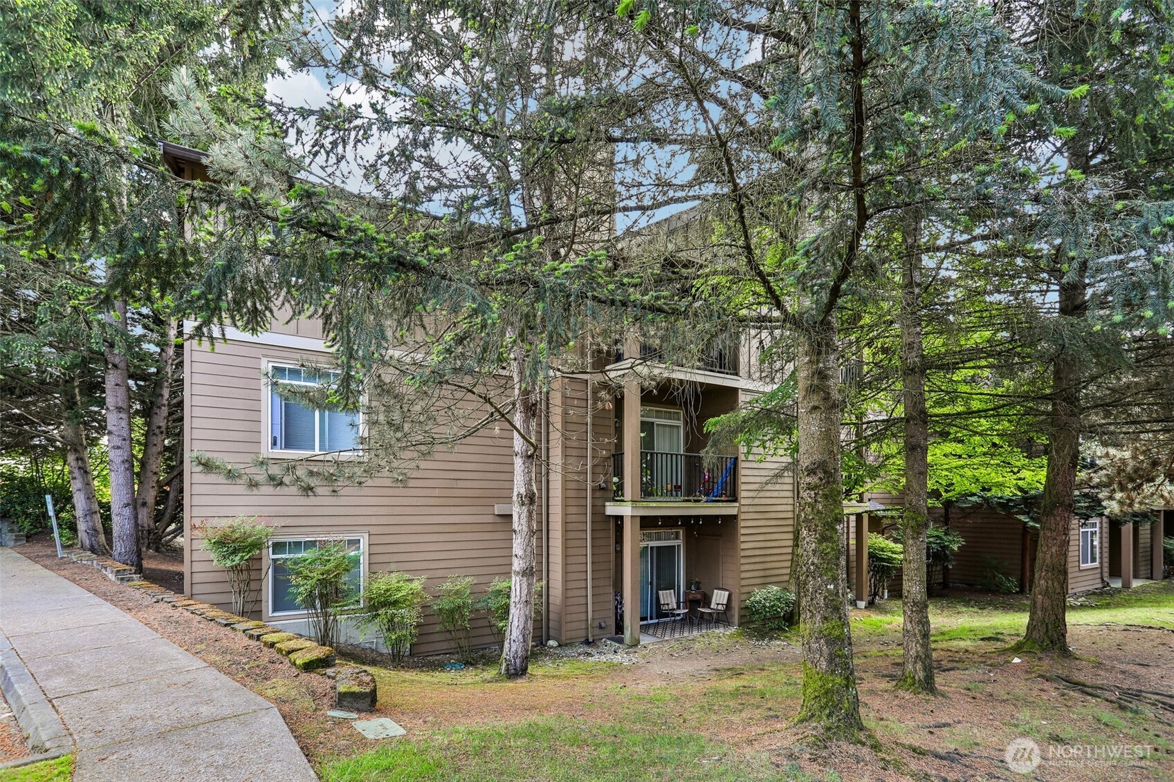 18930 Bothell Everett Highway, Unit E301 Bothell, WA 98012 - Photo 26 of 28 a front view of a house with a garden