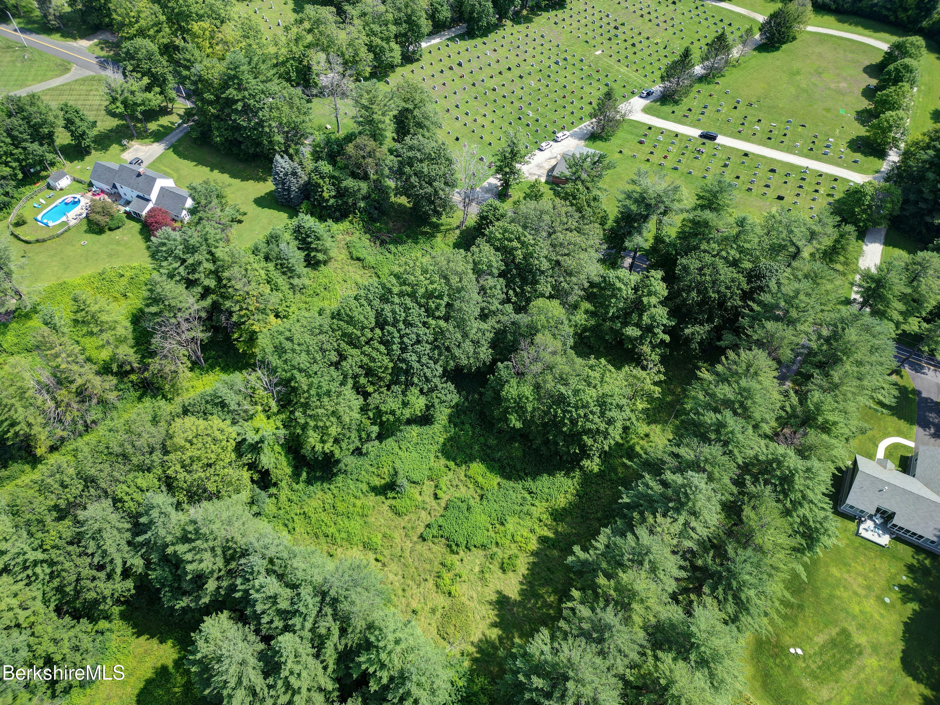 235 Spring Street Lee, MA 01238 - Photo 1 of 5 an aerial view of residential house with outdoor space and trees all around