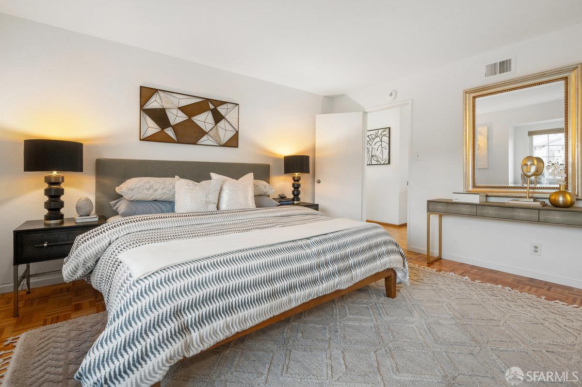 200 Bayview Circle San Francisco, CA 94124 - Photo 22 of 50 a bedroom with a bed and a dresser