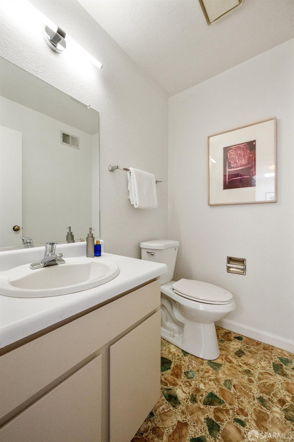 200 Bayview Circle San Francisco, CA 94124 - Photo 31 of 50 a bathroom with a toilet sink and mirror
