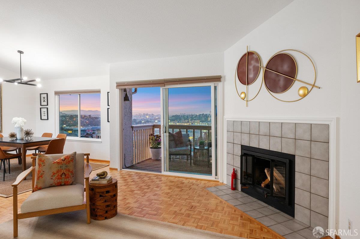 200 Bayview Circle San Francisco, CA 94124 - Photo 4 of 50 a living room with furniture a fireplace and a floor to ceiling window