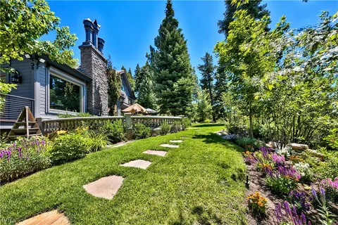 a view of a house with swimming pool and sitting area