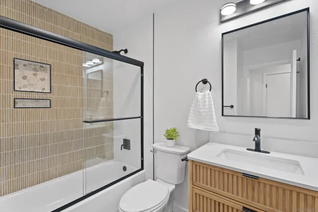 a bathroom with a sink toilet and shower