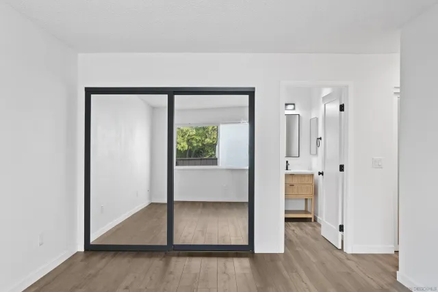 an entryway at an empty room and wooden floor