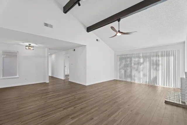 wooden floor in an empty room with a window