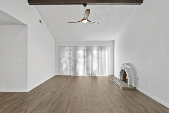 a view of a room with wooden floor and a window