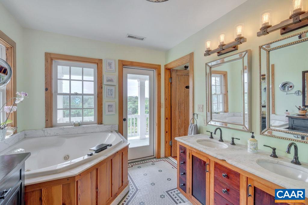 3609 Stony Point Road Charlottesville, VA 22911 - Photo 30 of 58 a spacious bathroom with sinks mirror and a bathtub
