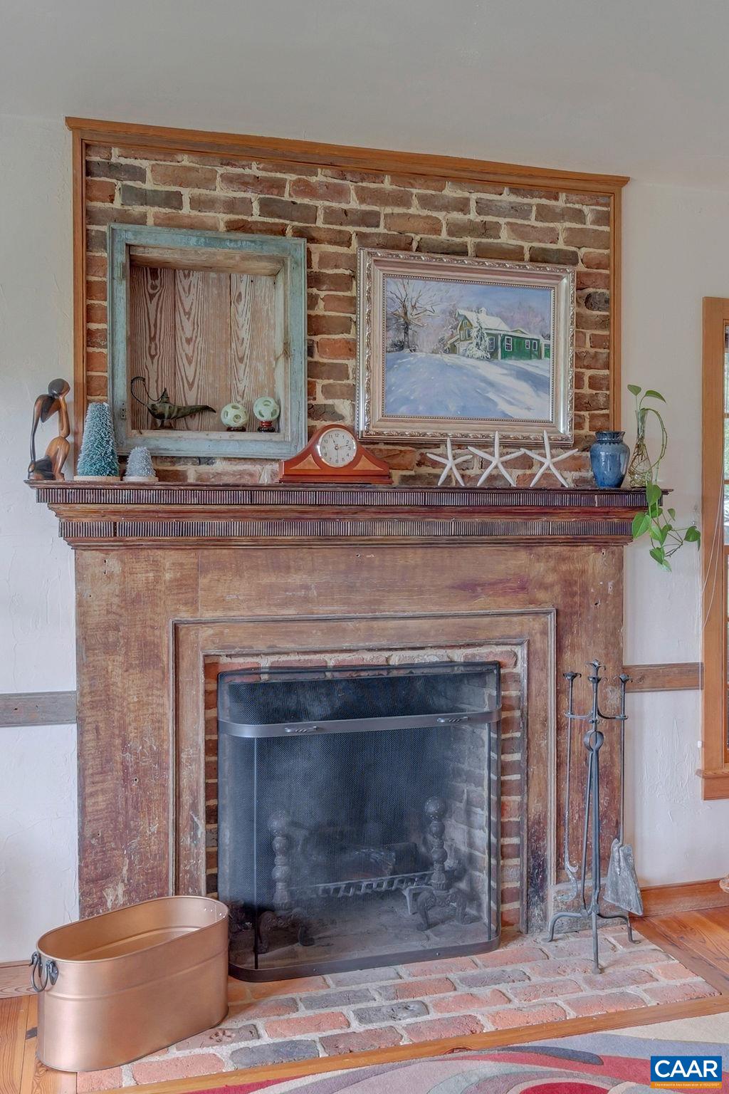 3609 Stony Point Road Charlottesville, VA 22911 - Photo 8 of 58 a fireplace with a clock on the top