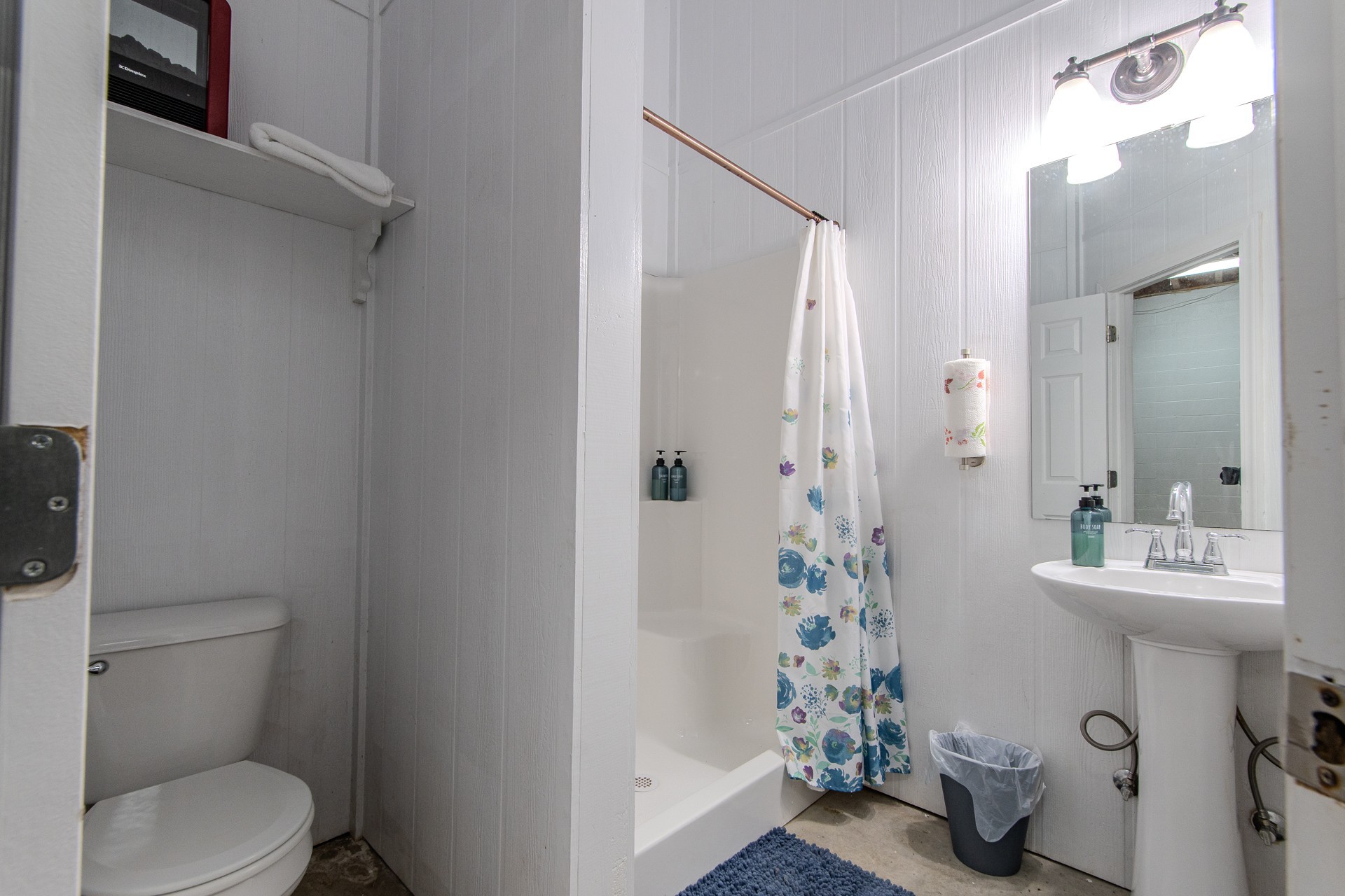 1040 Whites Creek Lane Decaturville, TN 38329 - Photo 47 of 80 a bathroom with a sink a toilet and shower curtain