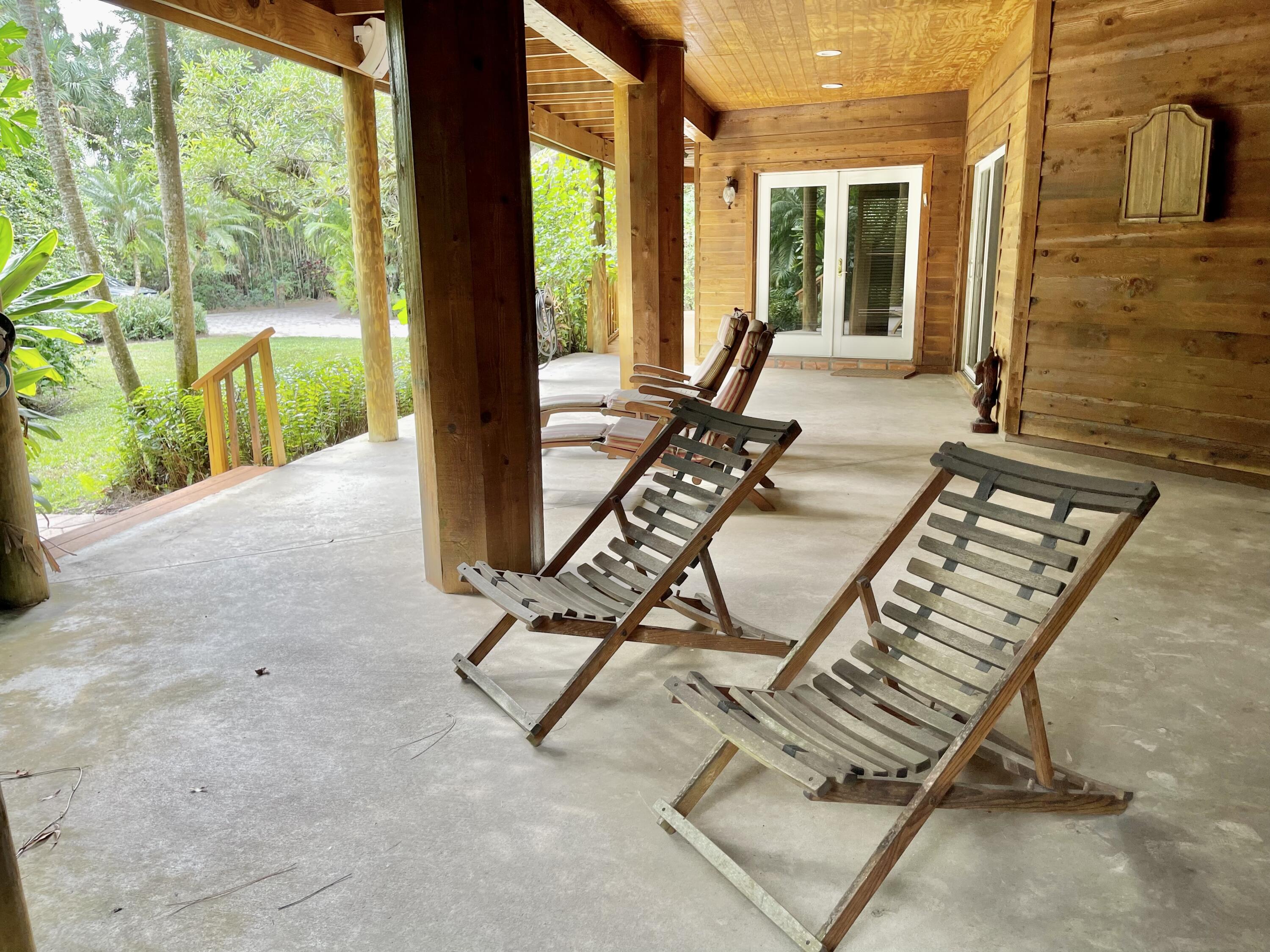 9470 Sandy Run Road Jupiter, FL 33478 - Photo 13 of 48 a view of a patio with a couple of chairs