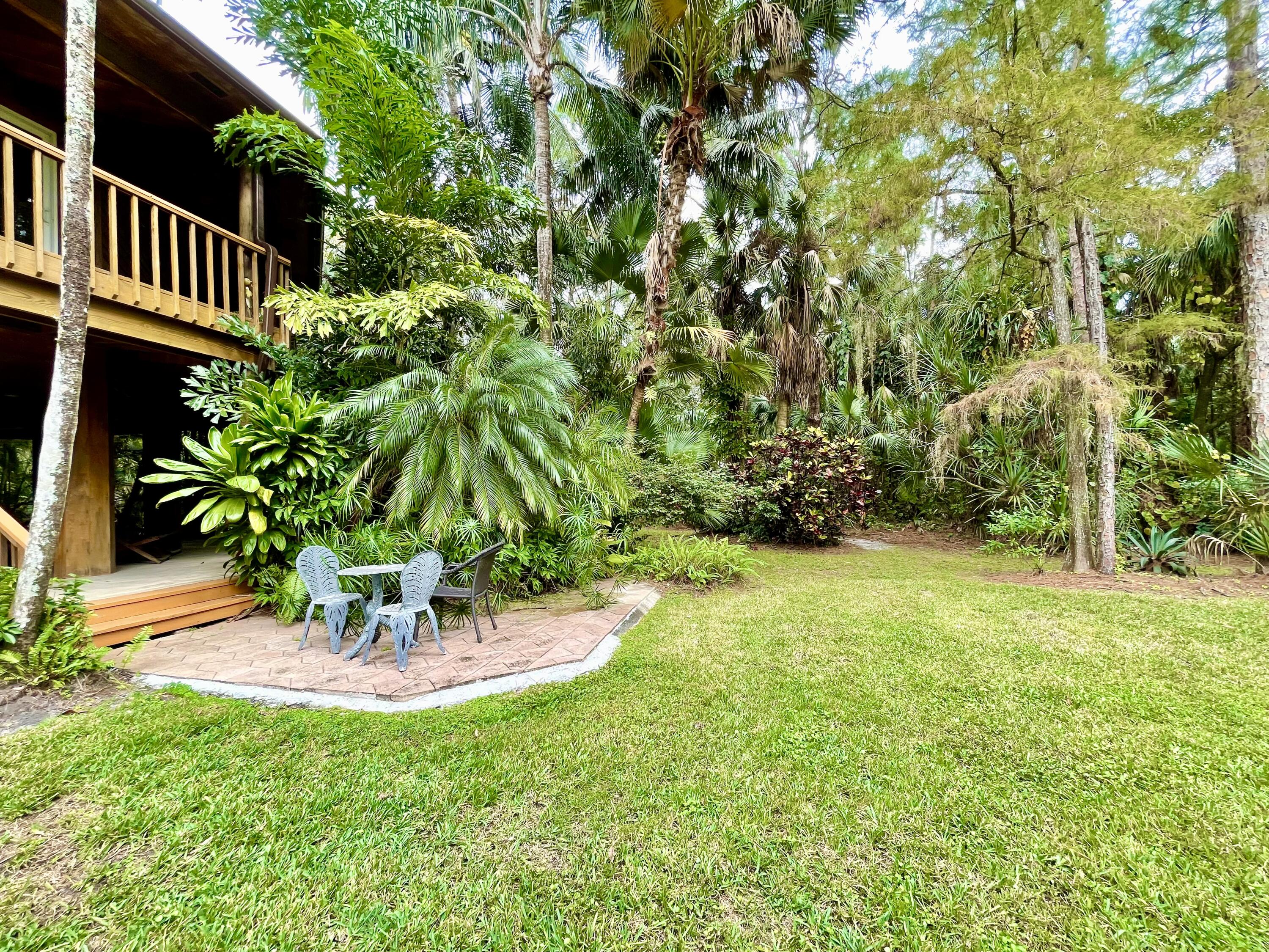 9470 Sandy Run Road Jupiter, FL 33478 - Photo 15 of 48 a view of a patio with a table and chairs