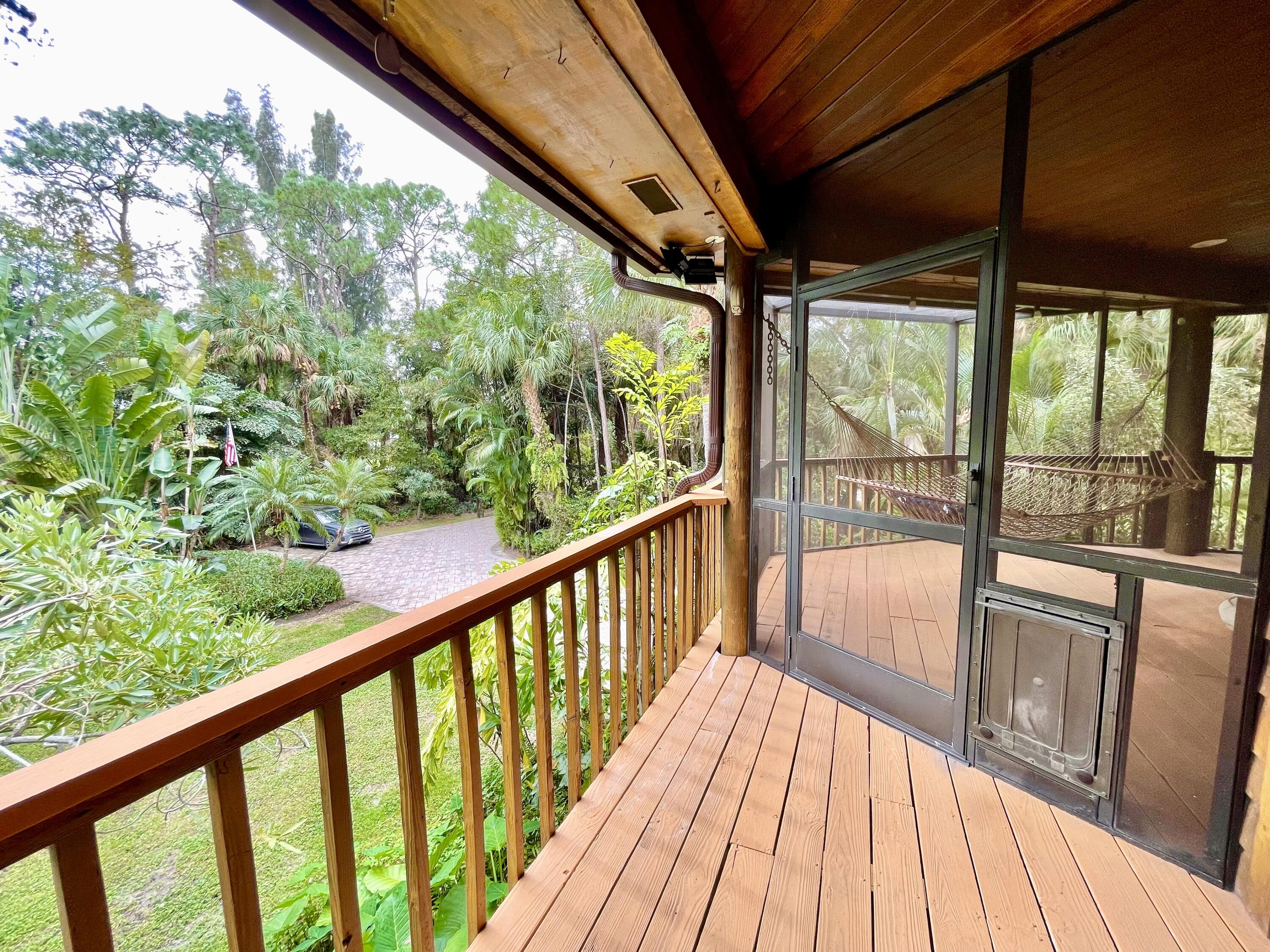 9470 Sandy Run Road Jupiter, FL 33478 - Photo 18 of 48 a view of balcony with wooden floor