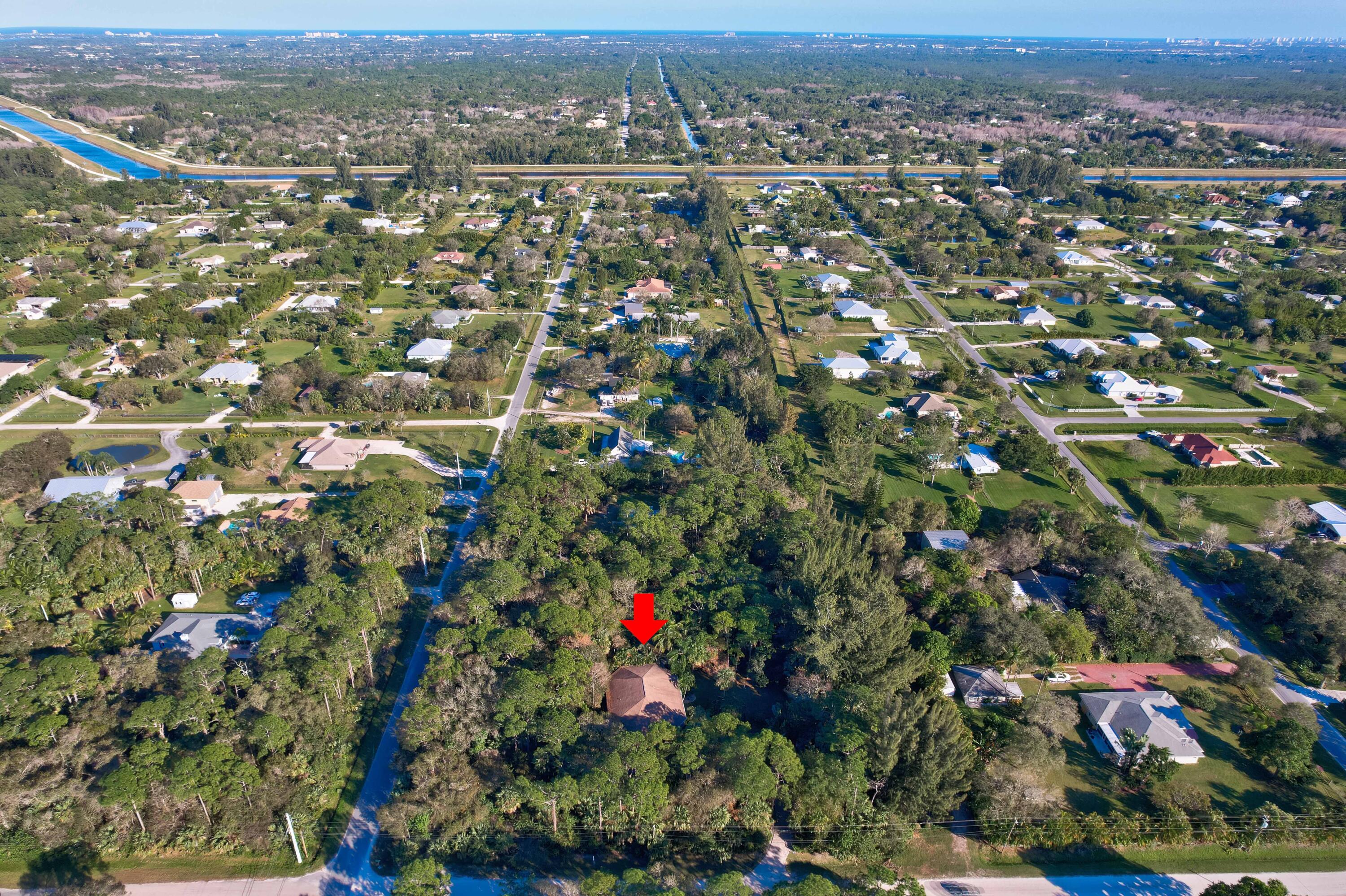9470 Sandy Run Road Jupiter, FL 33478 - Photo 2 of 48 an aerial view of residential houses with outdoor space