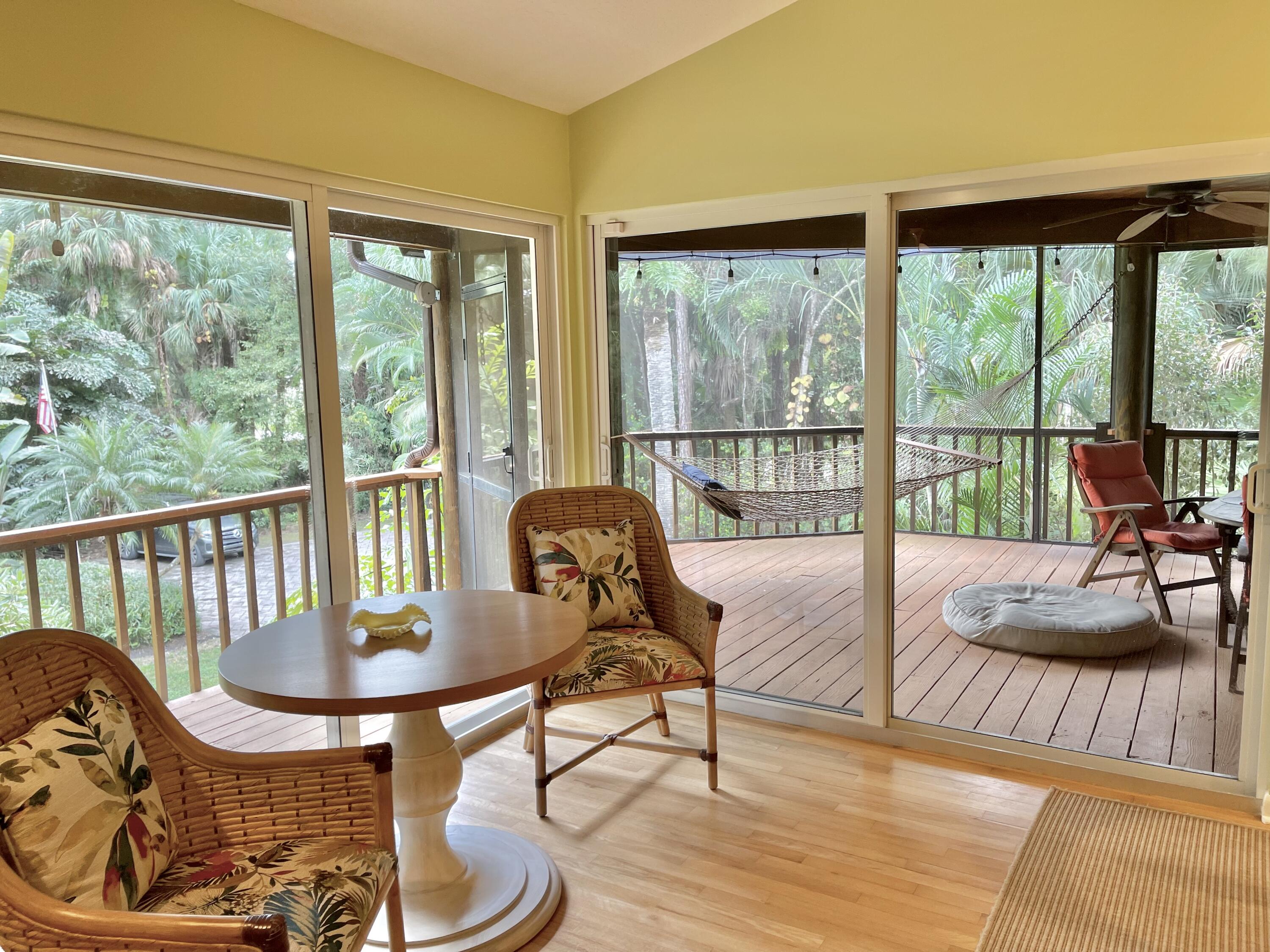 9470 Sandy Run Road Jupiter, FL 33478 - Photo 24 of 48 a living room with furniture and a floor to ceiling window
