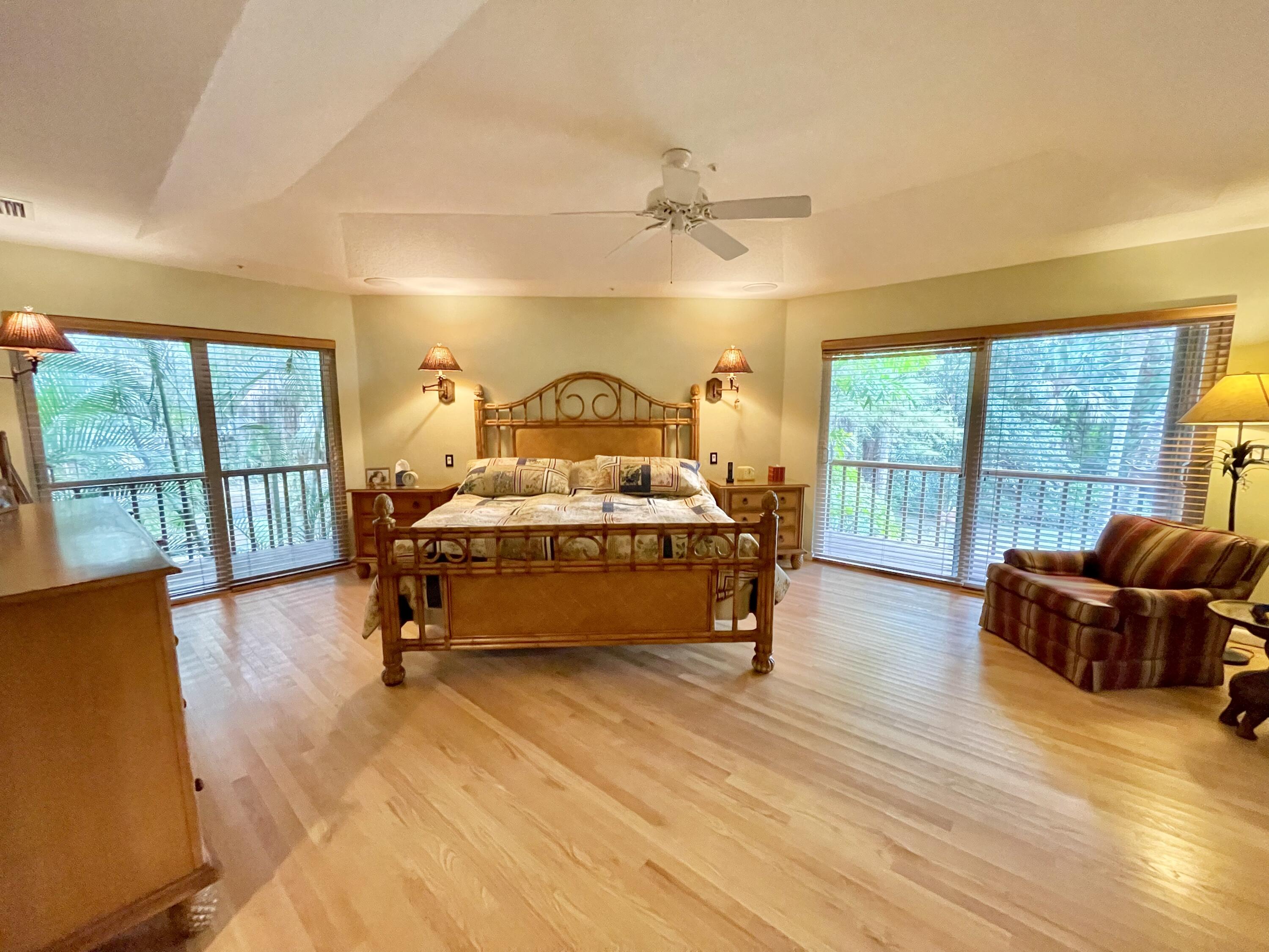 9470 Sandy Run Road Jupiter, FL 33478 - Photo 31 of 48 a bedroom with furniture and large windows