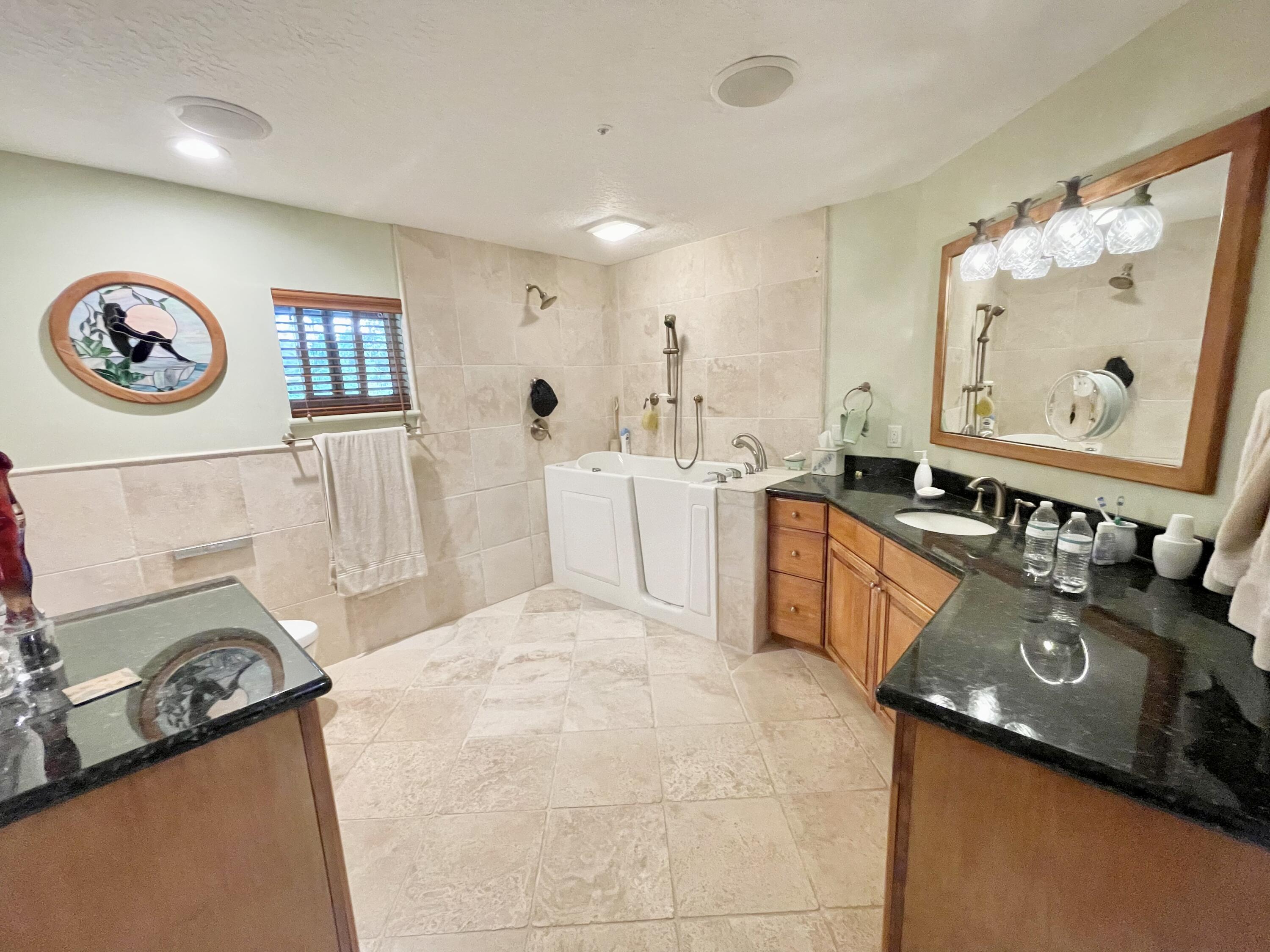 9470 Sandy Run Road Jupiter, FL 33478 - Photo 33 of 48 a view of a kitchen with stainless steel appliances granite countertop a stove and a sink