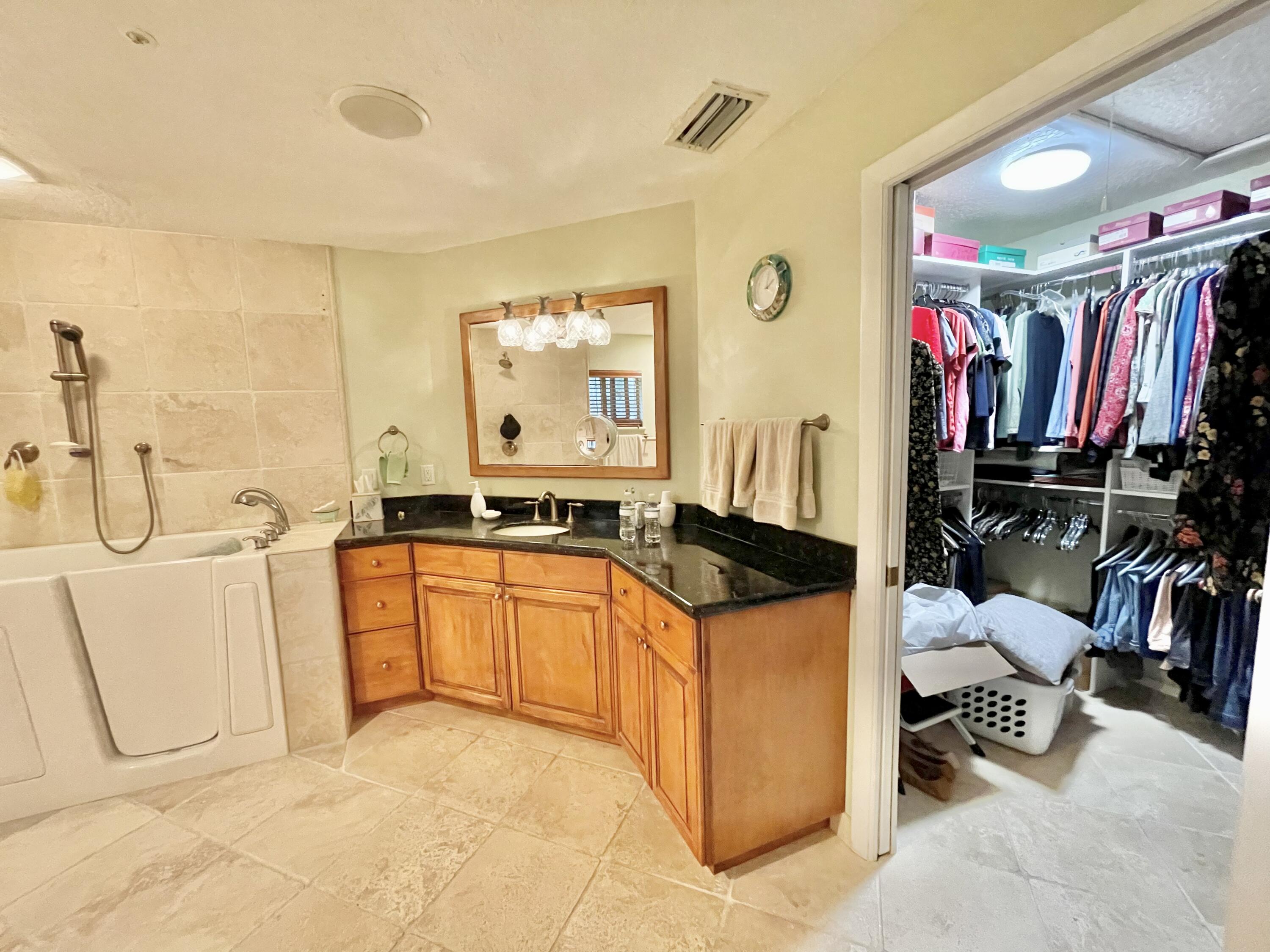 9470 Sandy Run Road Jupiter, FL 33478 - Photo 34 of 48 a large white kitchen with a sink and a refrigerator