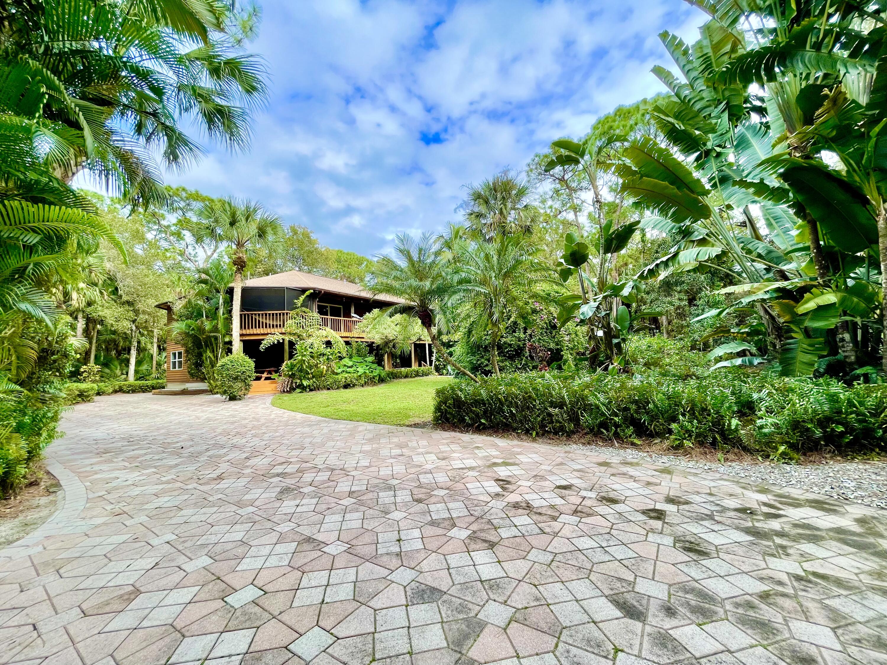 9470 Sandy Run Road Jupiter, FL 33478 - Photo 4 of 48 a view of a garden with plants