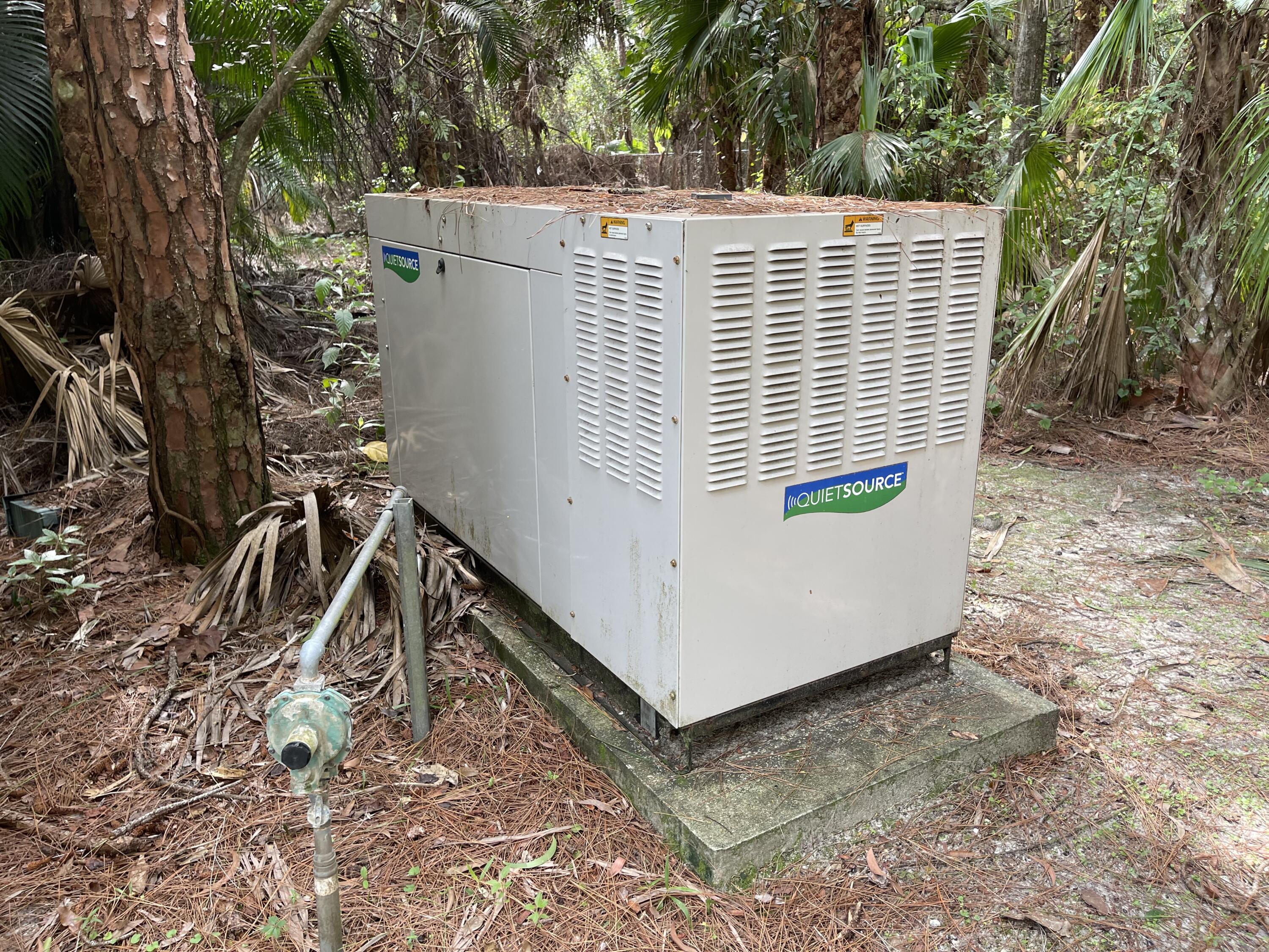 9470 Sandy Run Road Jupiter, FL 33478 - Photo 47 of 48 a view of a backyard with plants and wooden fence
