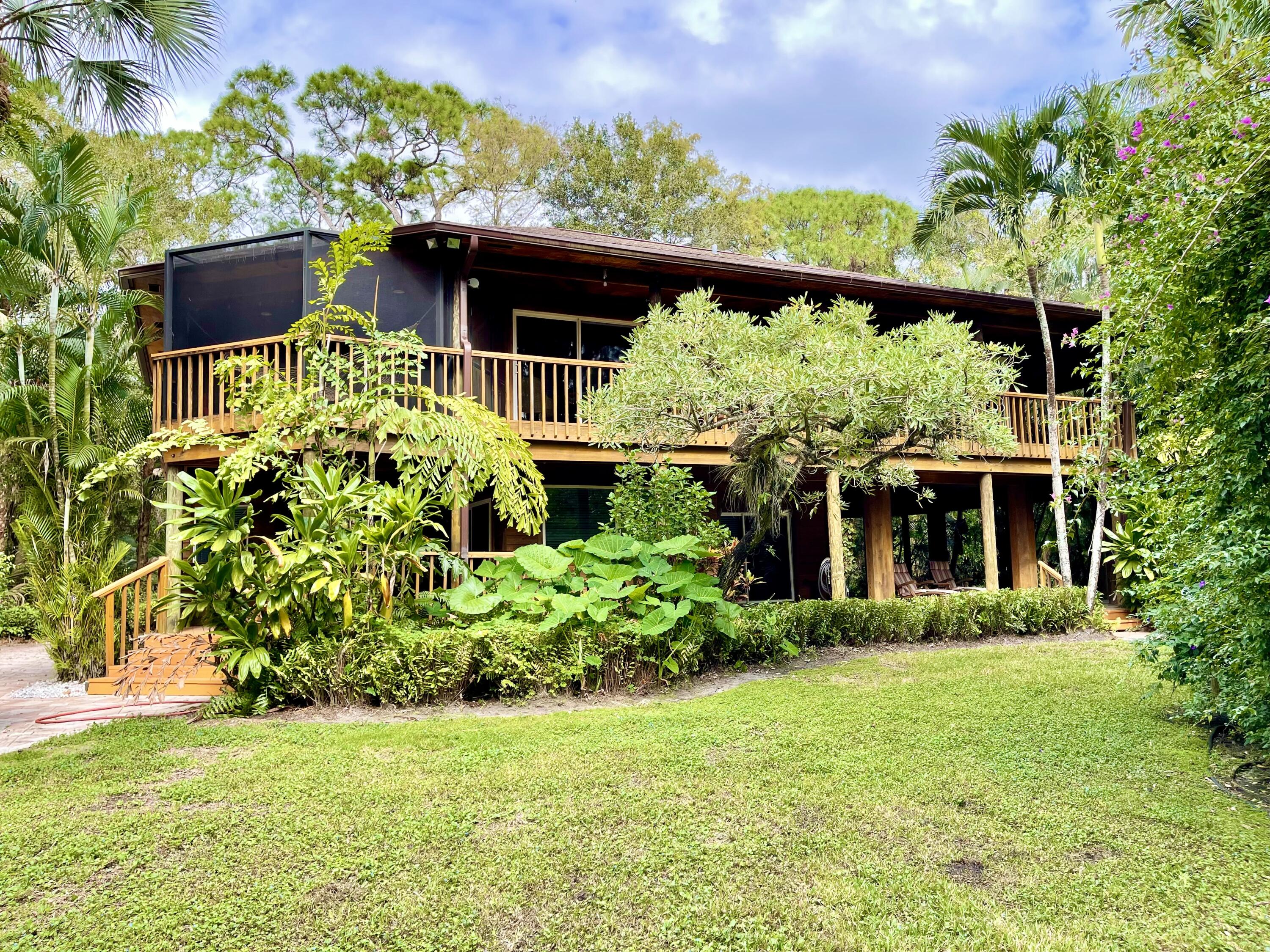 9470 Sandy Run Road Jupiter, FL 33478 - Photo 5 of 48 a front view of a house with a yard