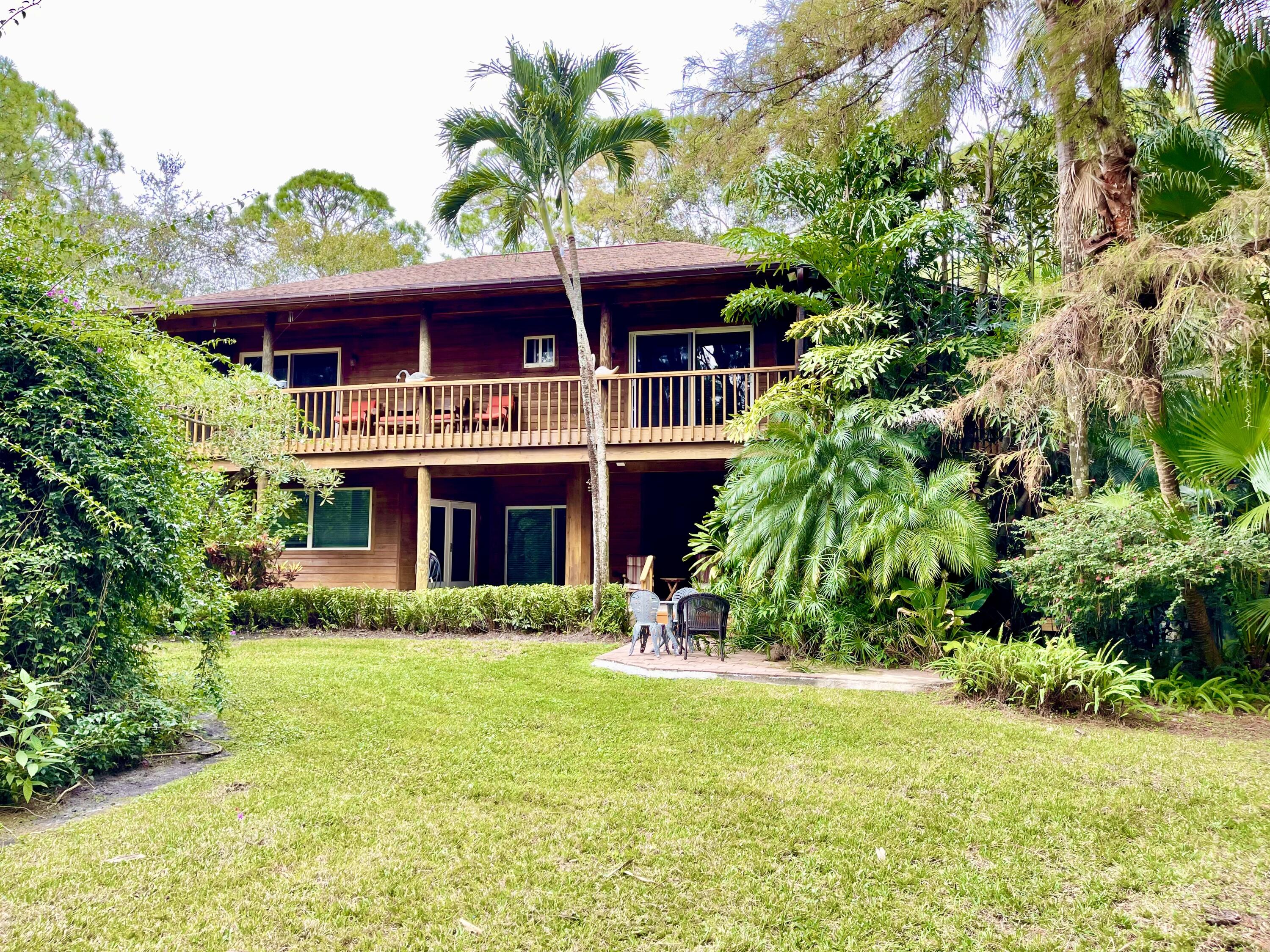 9470 Sandy Run Road Jupiter, FL 33478 - Photo 6 of 48 a front view of house with yard and green space