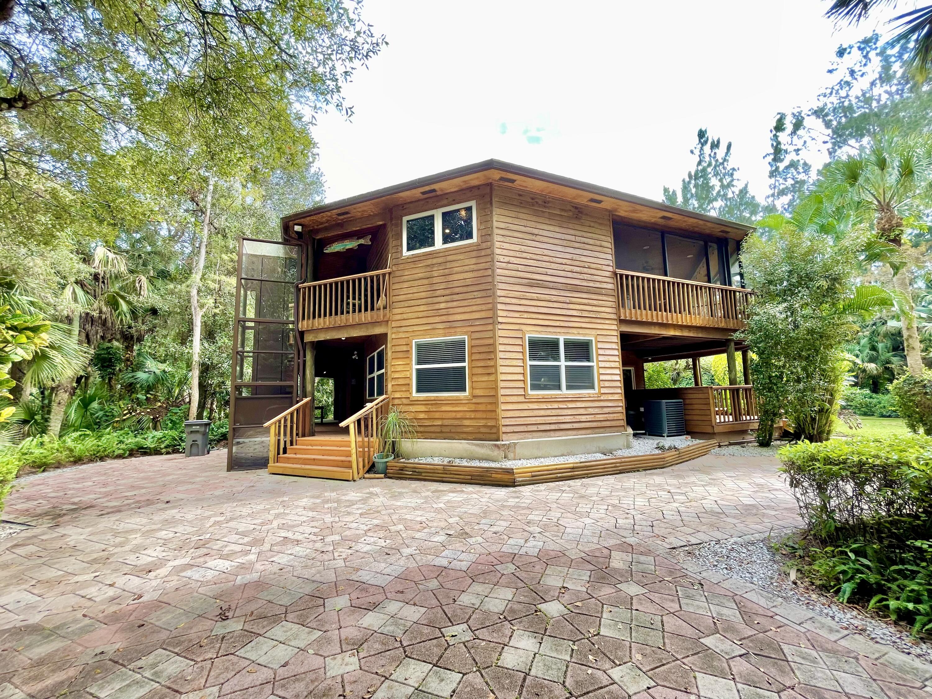 9470 Sandy Run Road Jupiter, FL 33478 - Photo 7 of 48 a view of a house with backyard and sitting area