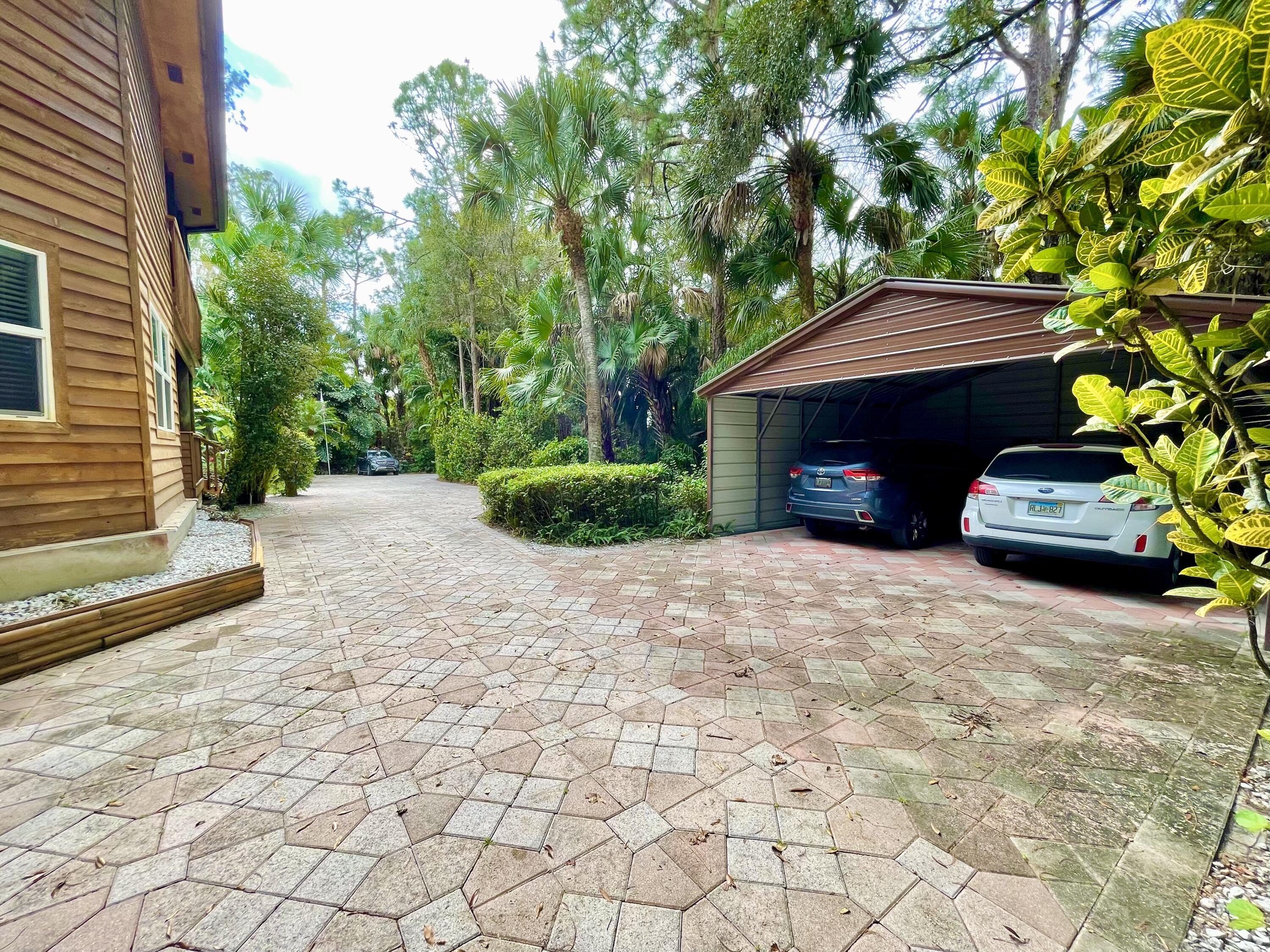 9470 Sandy Run Road Jupiter, FL 33478 - Photo 8 of 48 a front view of a house with a yard