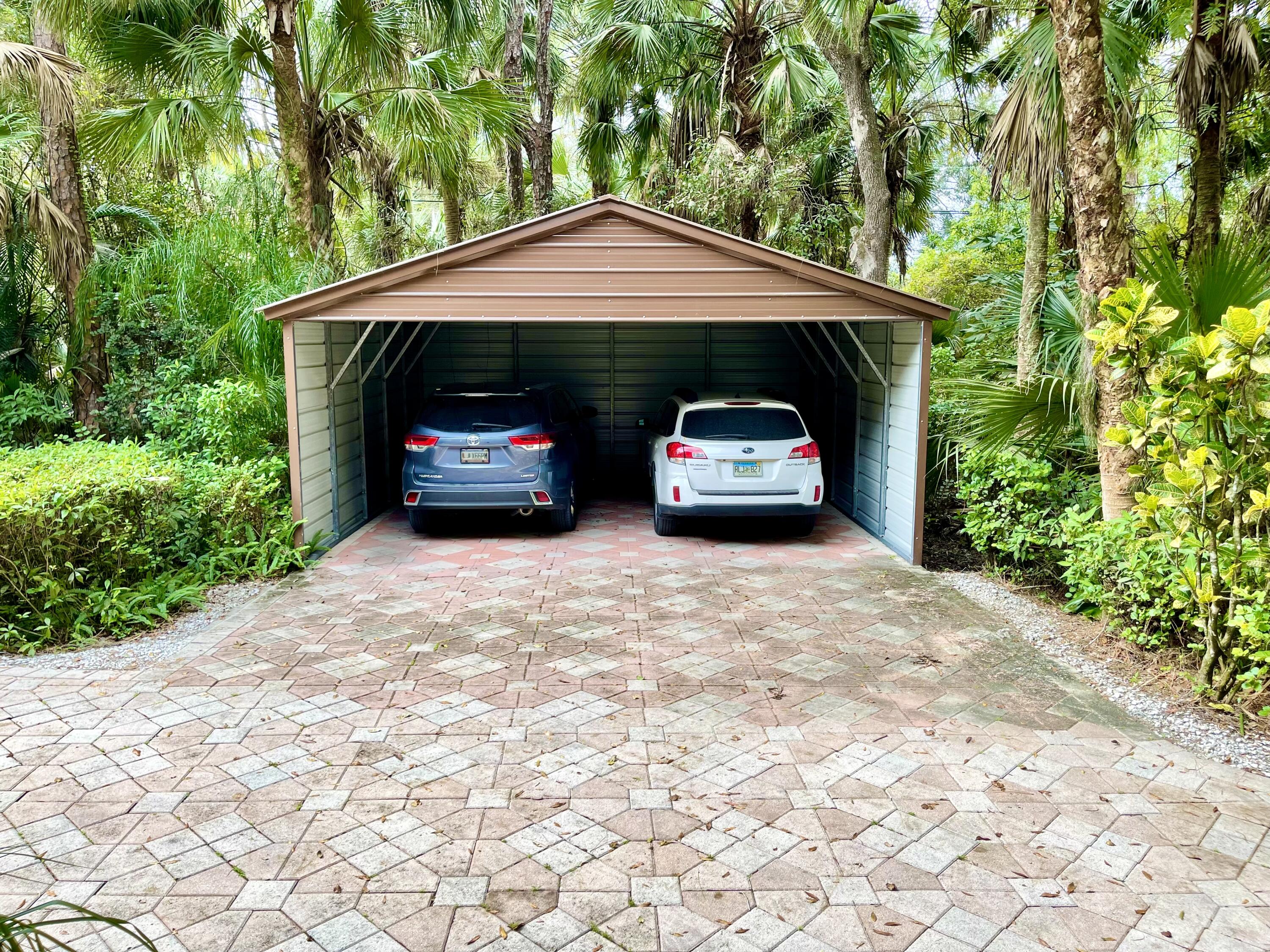 9470 Sandy Run Road Jupiter, FL 33478 - Photo 9 of 48 a view of car parked in front of house
