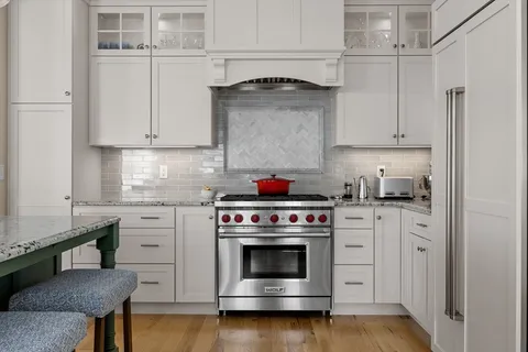 a kitchen with granite countertop a stove and a sink