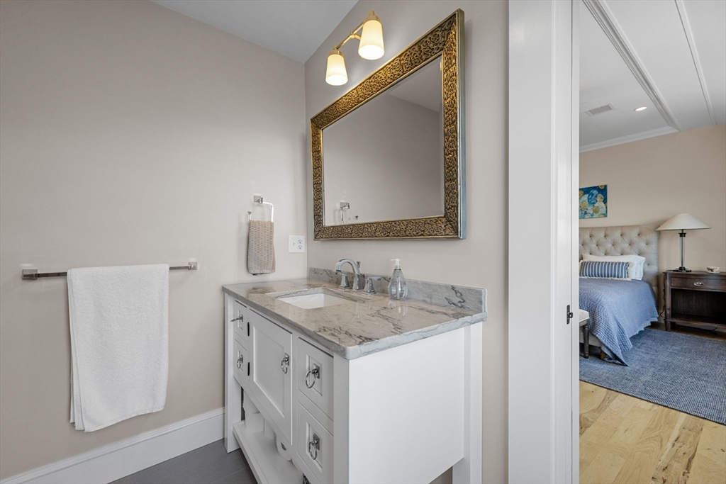 246 Stage Island Road Chatham, MA 02633 - Photo 21 of 37 a en suite bathroom with a sink and a mirror