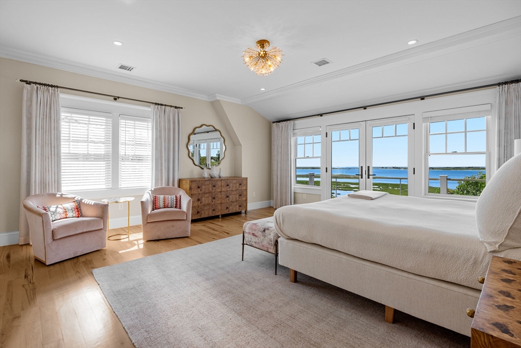 246 Stage Island Road Chatham, MA 02633 - Photo 24 of 37 a bed room with a bed couch and a large window