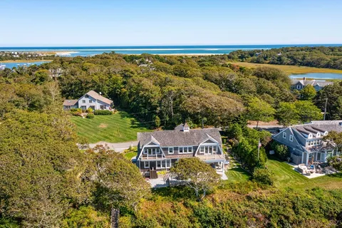 an aerial view of a house with a garden and lake view
