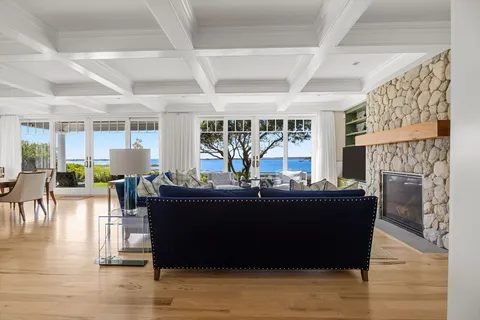 a living room with fireplace furniture and a floor to ceiling window