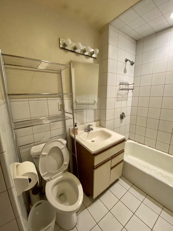 16 Royce Road, Unit 4 Boston, MA 02134 - Photo 4 of 4 a bathroom with a sink a toilet and shower