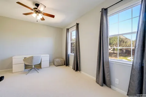 a workspace room with furniture and windows