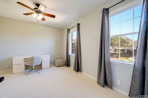 a workspace room with furniture and windows