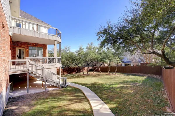 a view of a house with backyard porch and sitting area