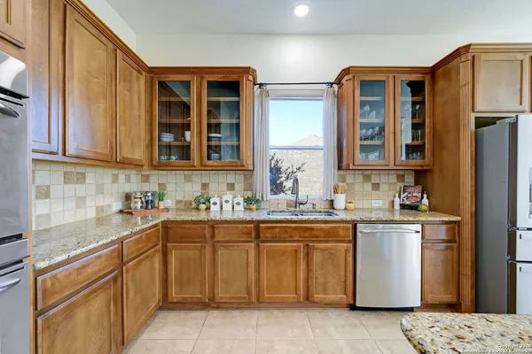 a kitchen with a sink stove and cabinets