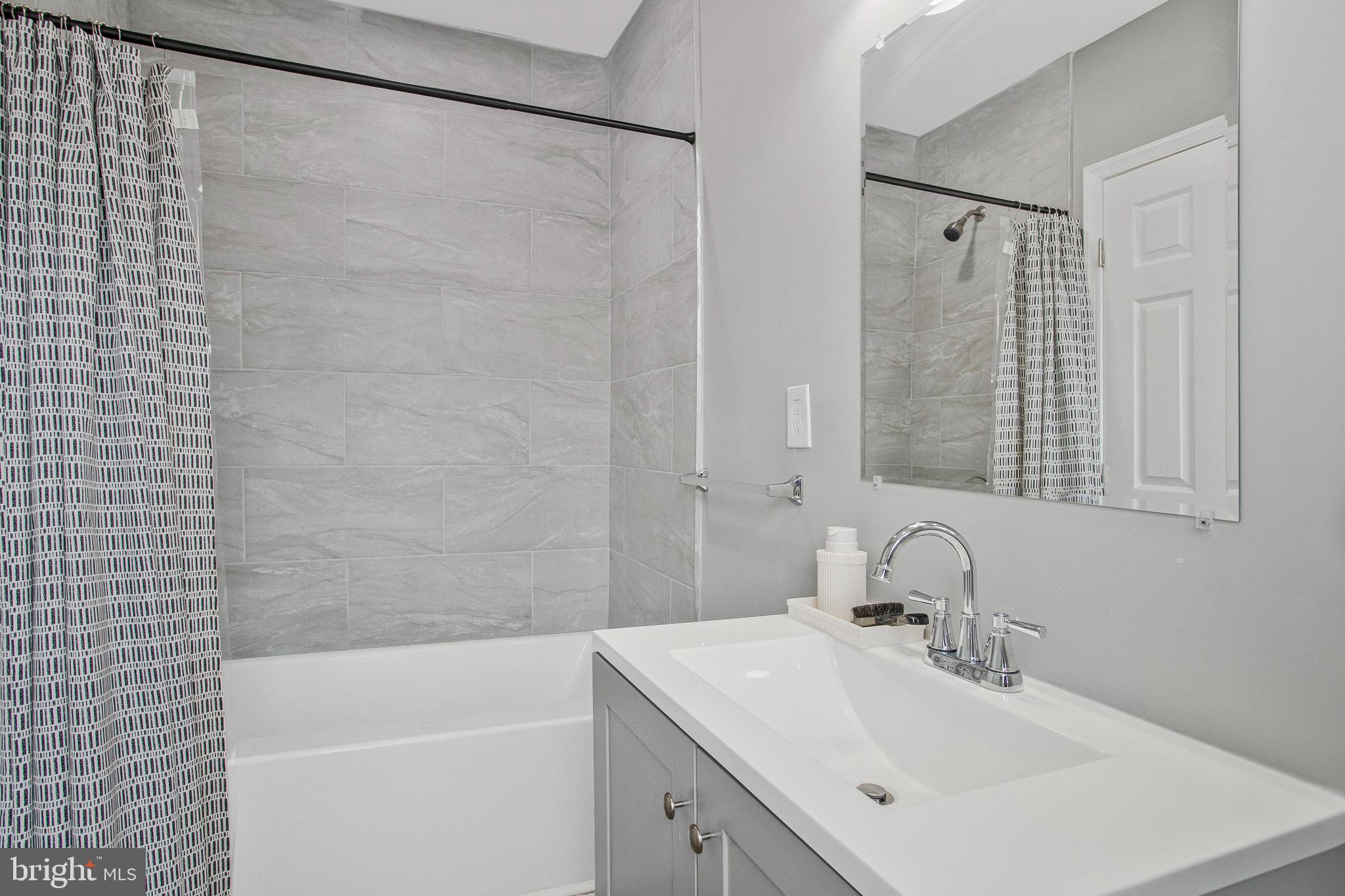 3417 Chestnut Avenue Baltimore, MD 21211 - Photo 11 of 14 a bathroom with a sink and a bathtub