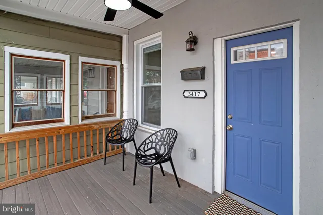 a view of a hallway with wooden floor and windows