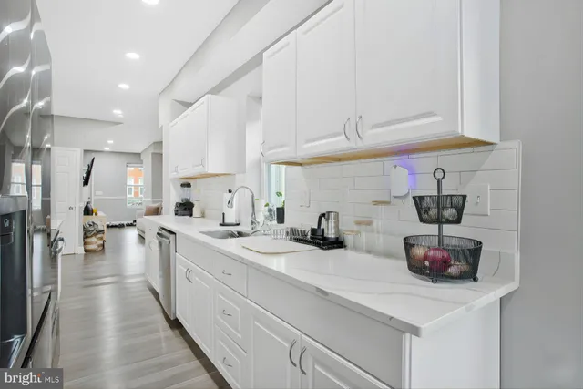 a kitchen with sink a stove and cabinets