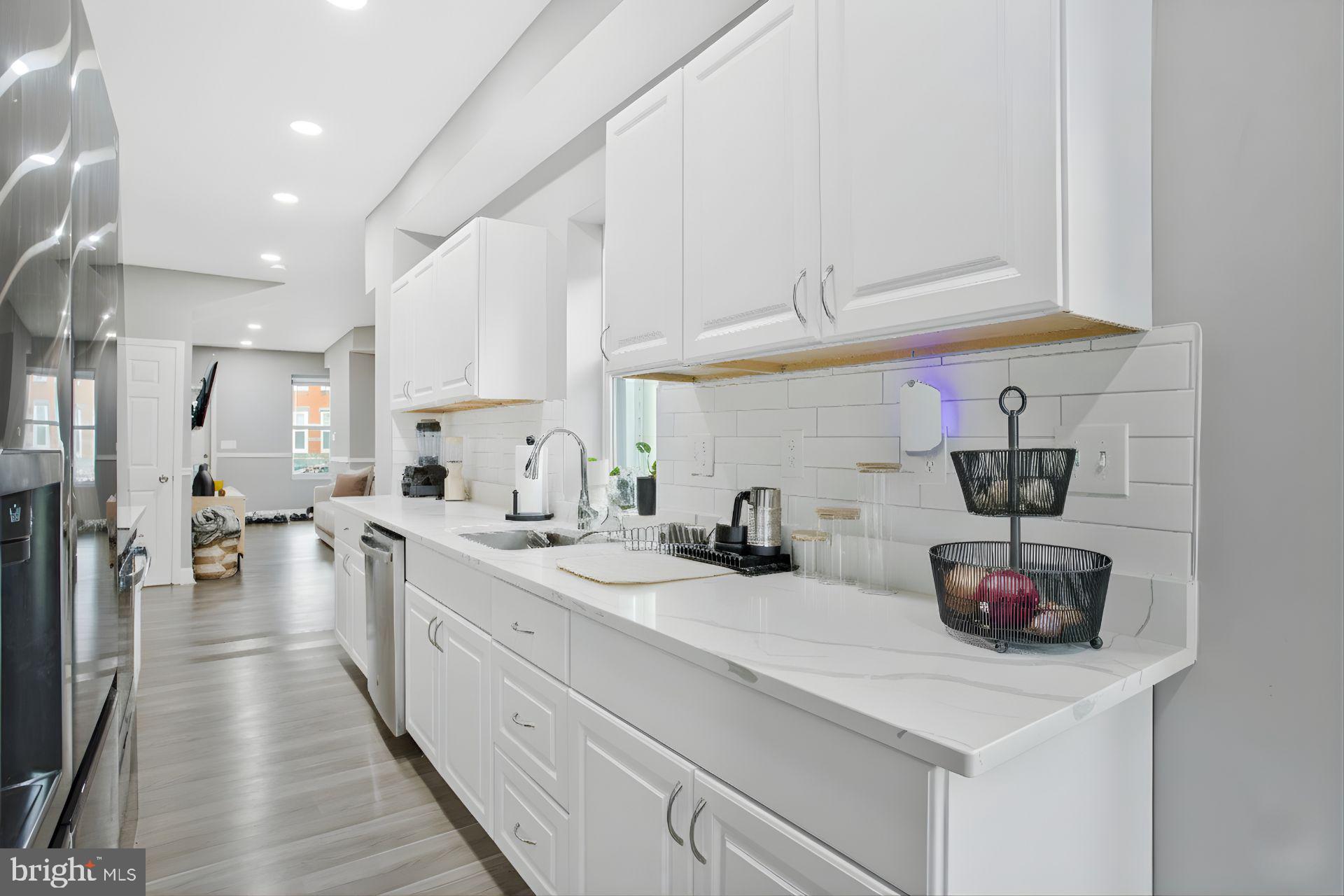 3417 Chestnut Avenue Baltimore, MD 21211 - Photo 6 of 14 a kitchen with sink a stove and cabinets