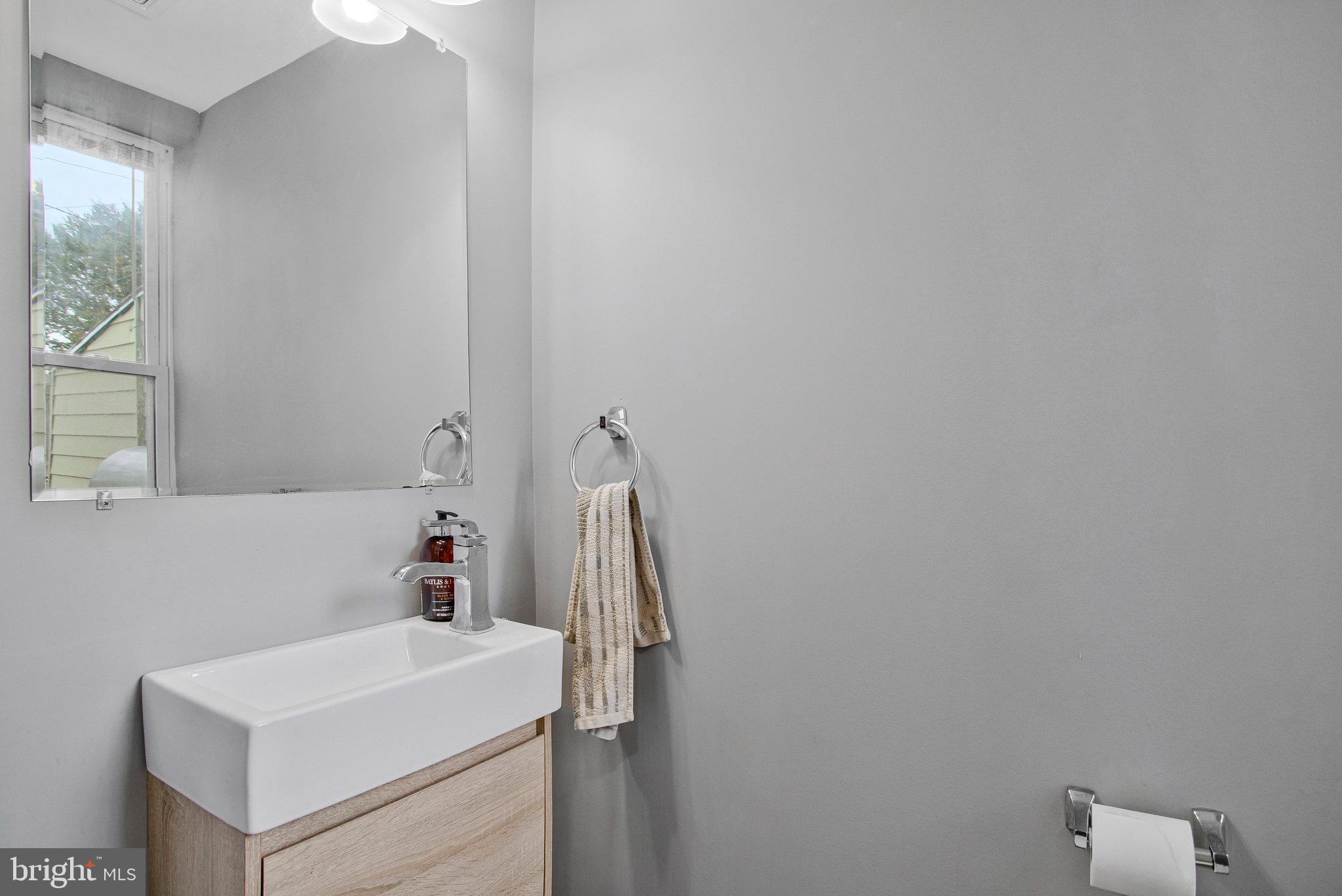 3417 Chestnut Avenue Baltimore, MD 21211 - Photo 7 of 14 a bathroom with a sink and a vanity