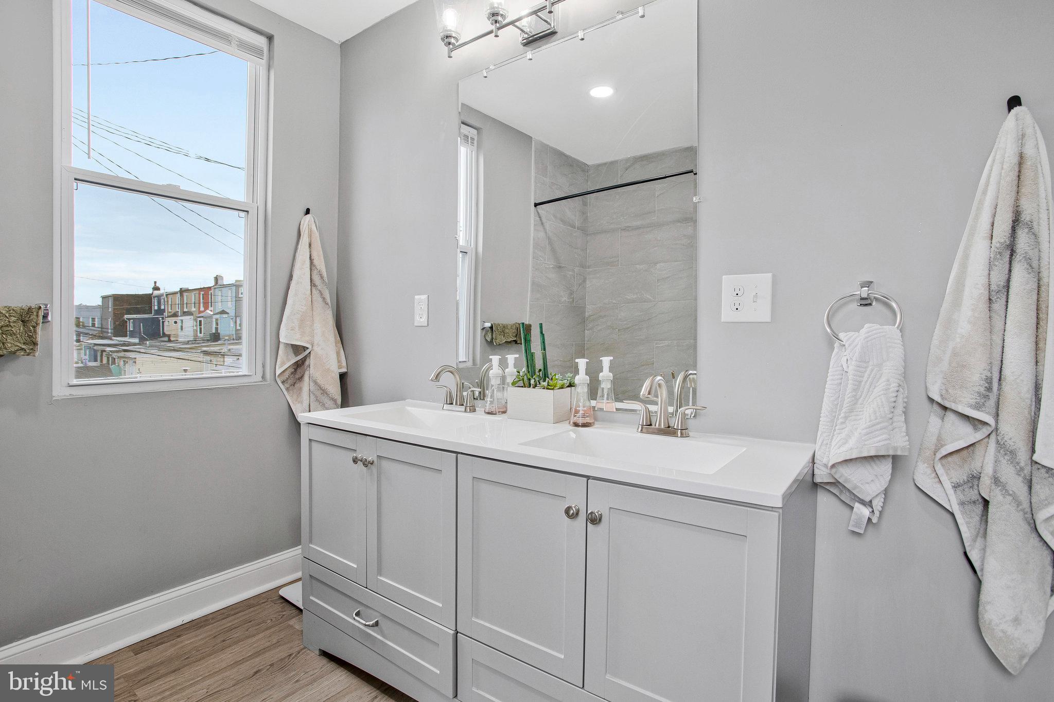3417 Chestnut Avenue Baltimore, MD 21211 - Photo 9 of 14 a bathroom with a sink and a mirror